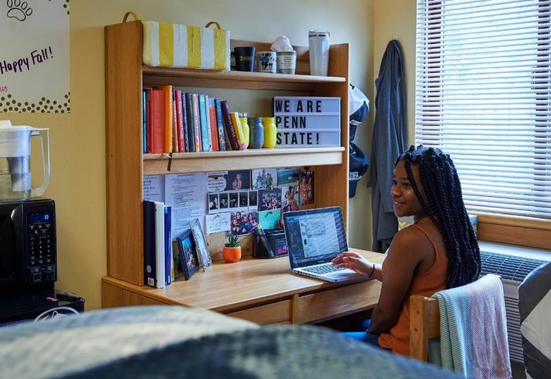 Female student studying at desk in residence hall 