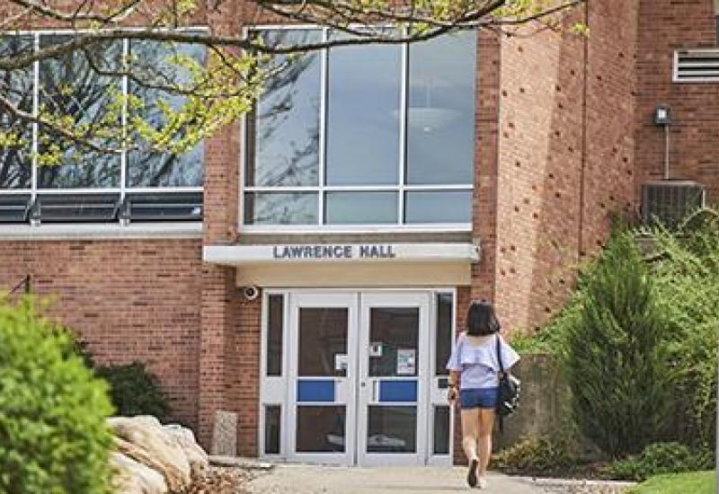 Lawrence Hall Exterior with female student walking