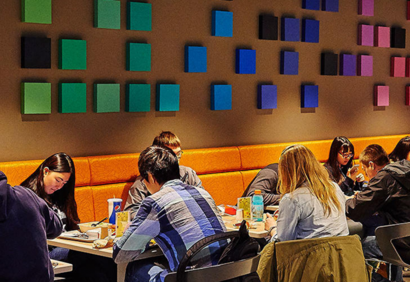 students dining at tables in the HUB