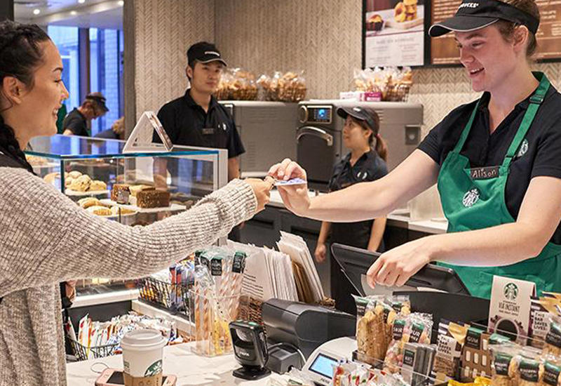 A student "swipes out hunger" at Starbucks witth her meal plan card