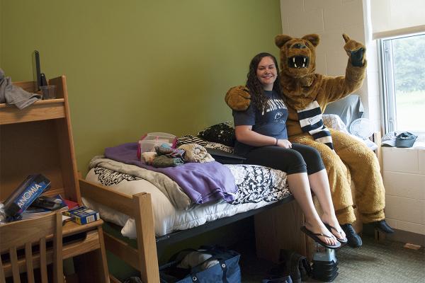 Nittany Lion with student in Juniata Hall room