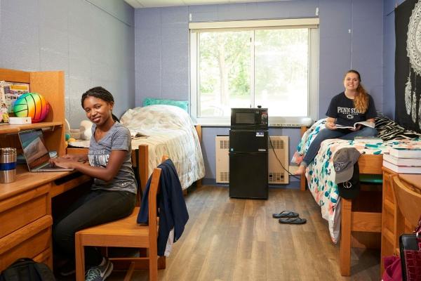 Two students sitting in residence hall room