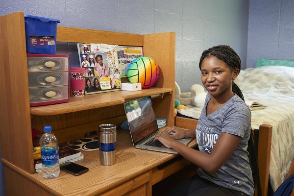 Student at desk in her room in Mont Alto Hall