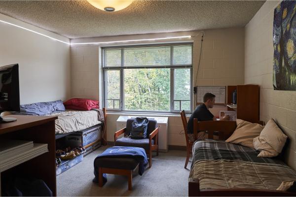 Dorm room with student working