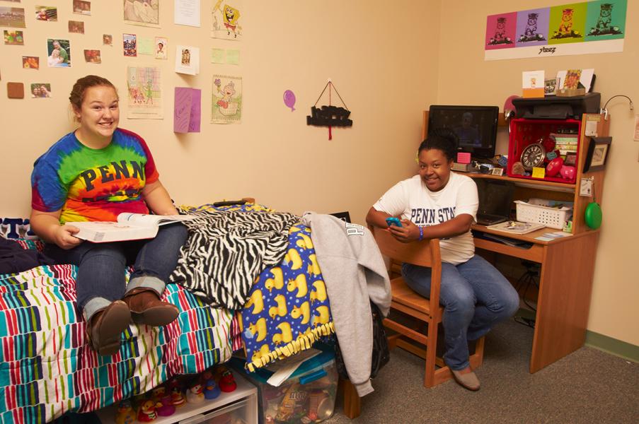 Two students sitting in their room in Cedar