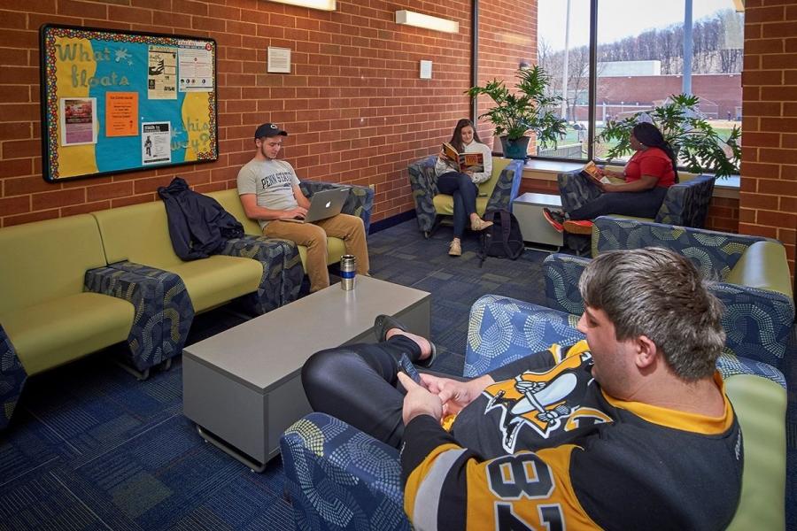 students sitting in lobby of spruce hall