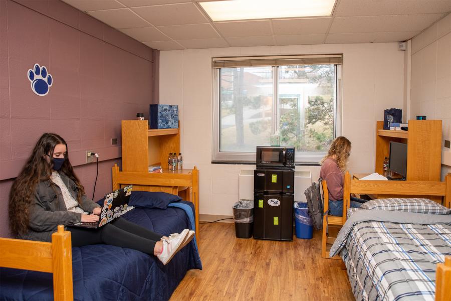 Double dorm room with students working