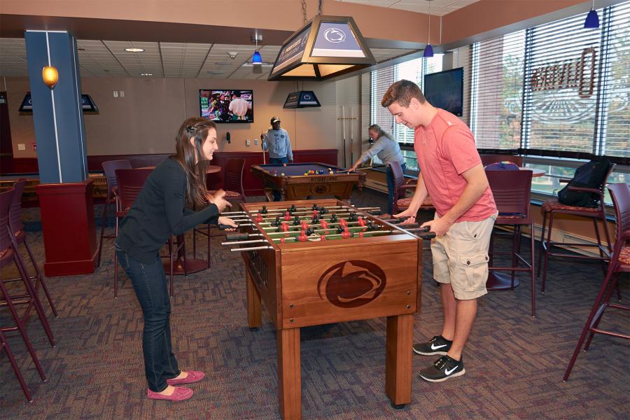 Students playing foosball in Oliver's Game Room in Lawrence Hall