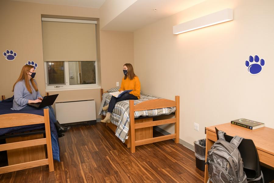 Masked students sitting in Trippe double room