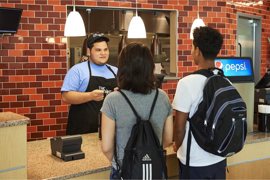 Outpost cashier with student customers