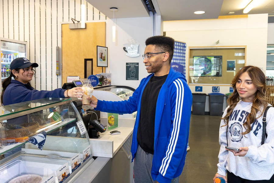 a student purchasing a drink at the Cyber Cafe at Berks campus