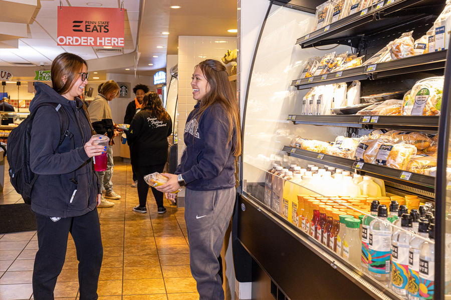two students socialize next to the grab and go case in Tullys at Berks campus