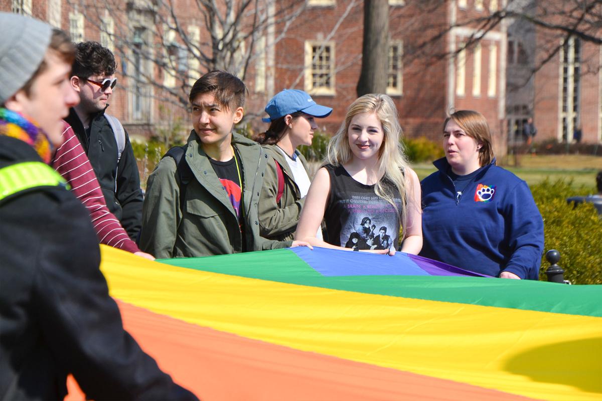 image of students holding a rainbow flag
