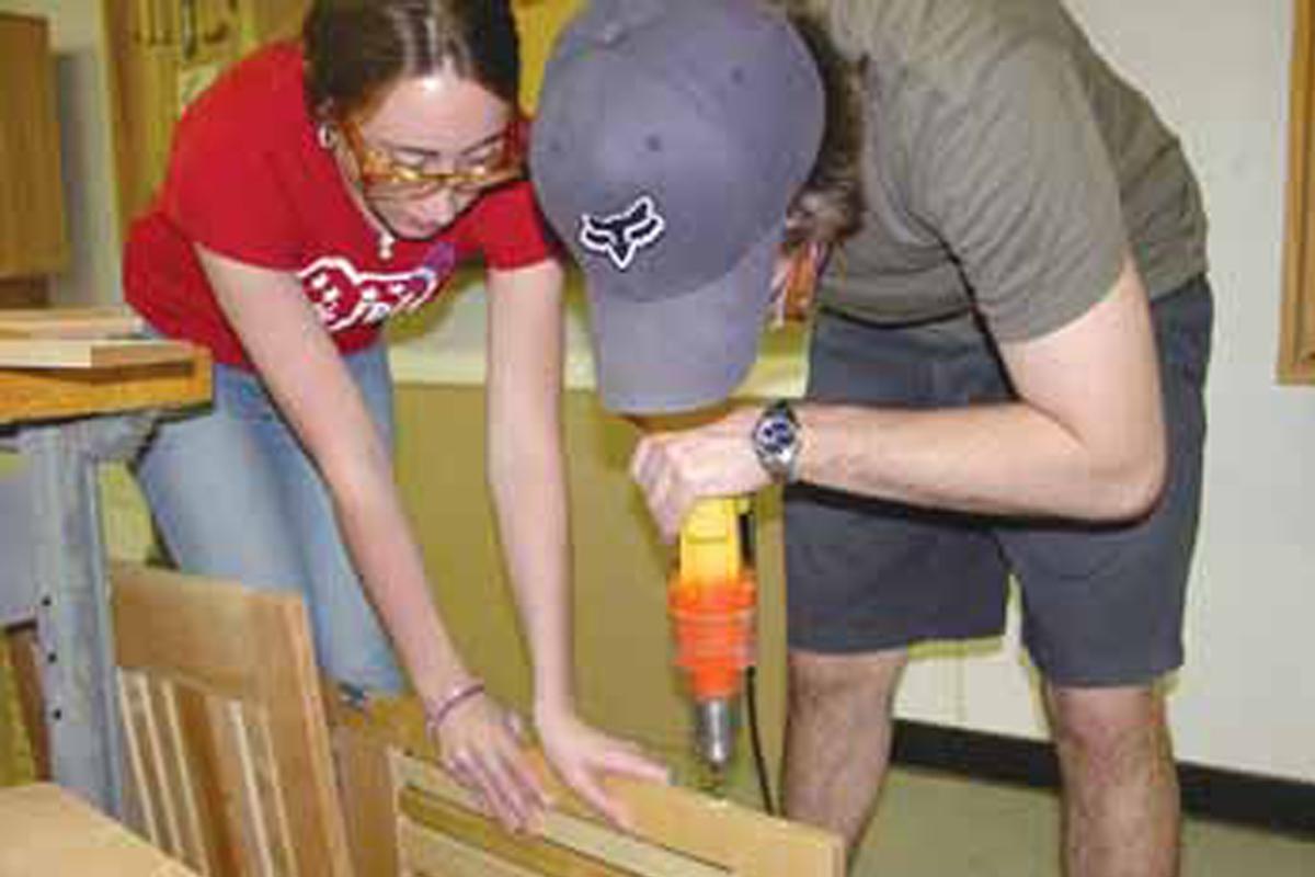 two students working on wood project