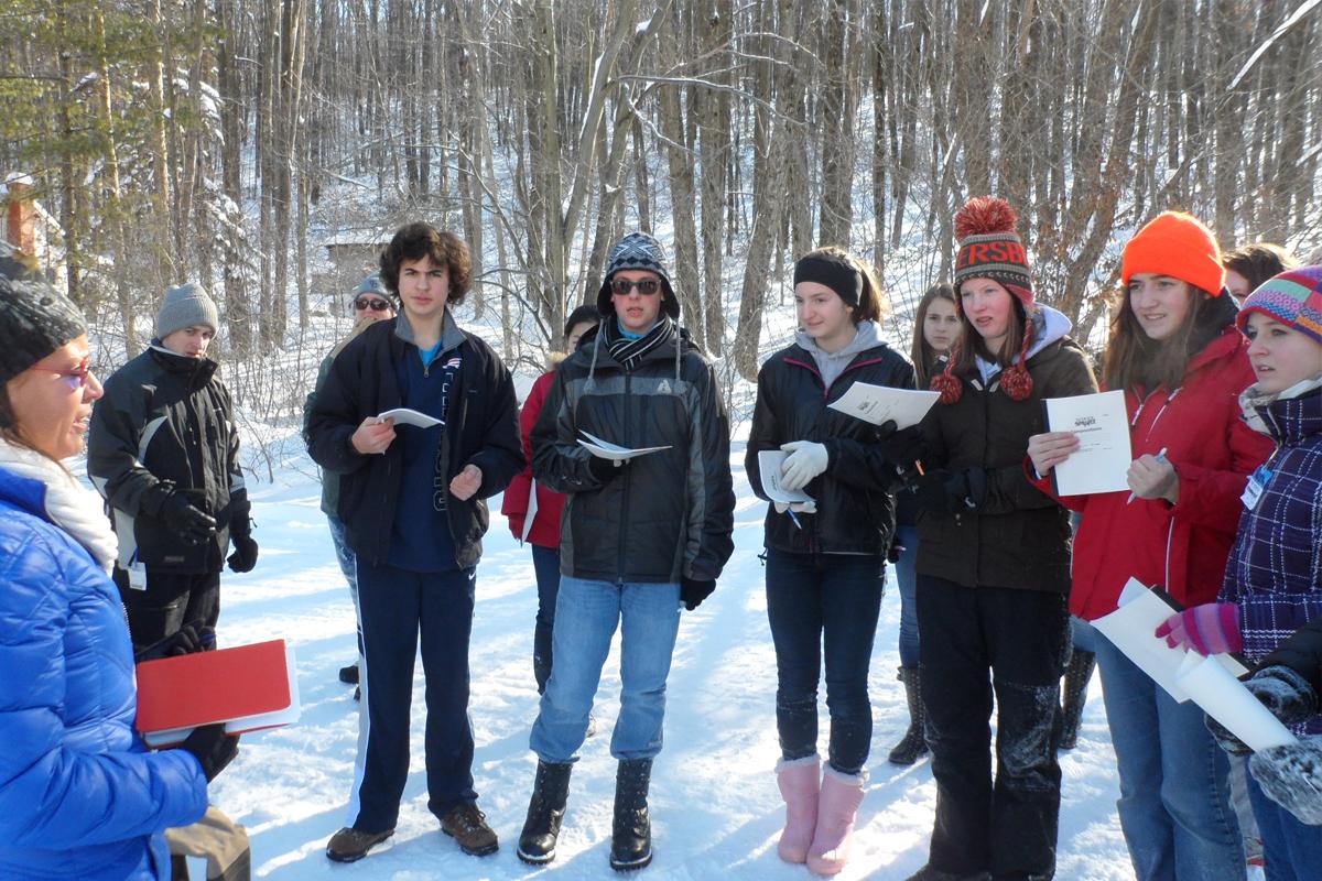 Students in the woods with snow on the ground