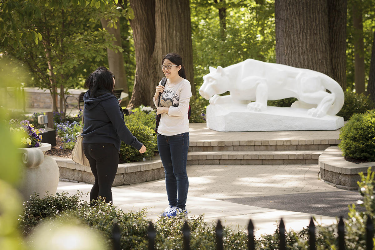 Students visit in front of Nittany Lion shrine