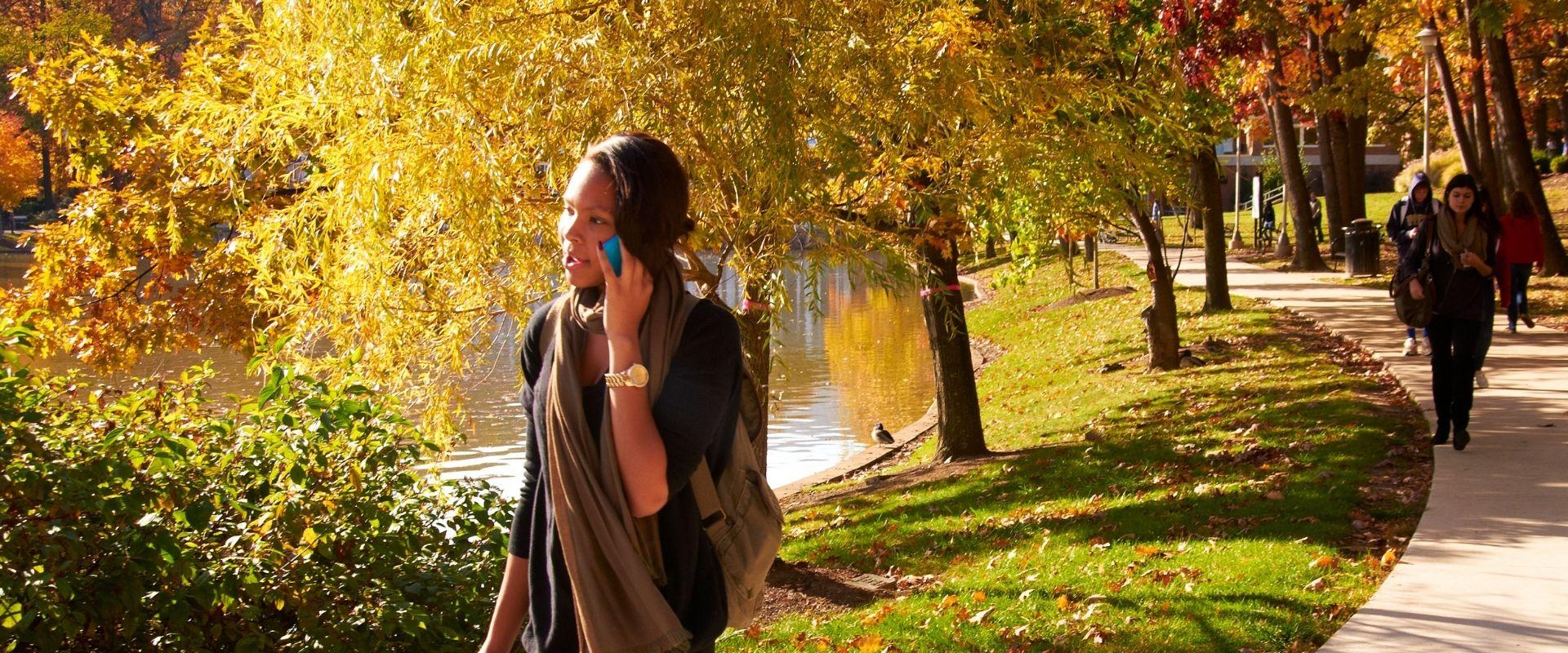 student walking on campus in fall