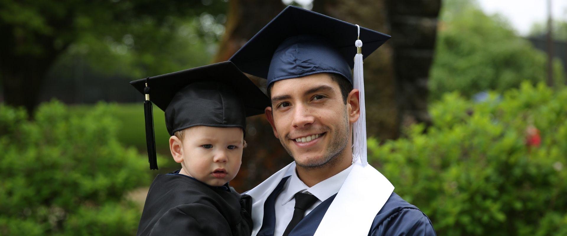 graduate student holding child