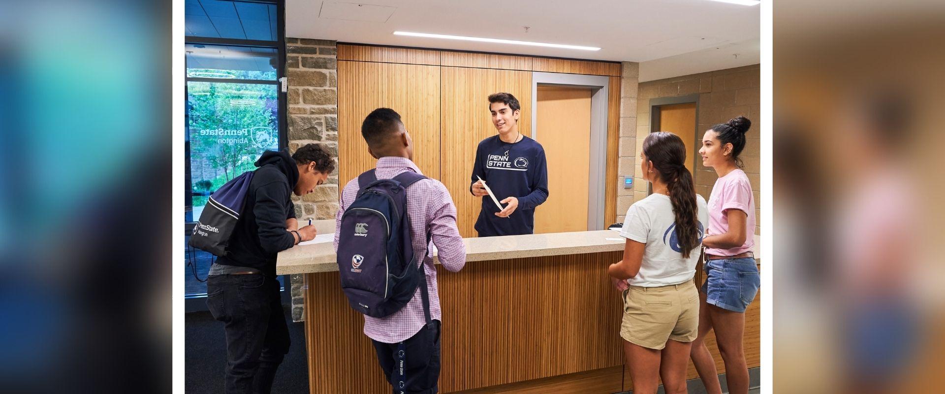 students at front desk