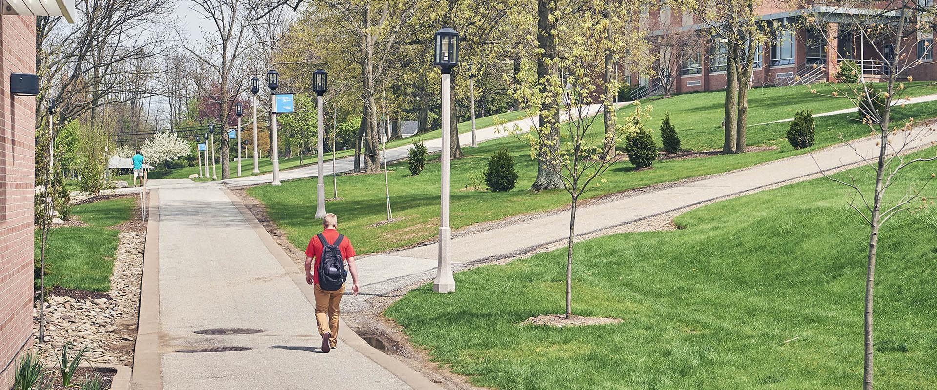 student walking past residence halls