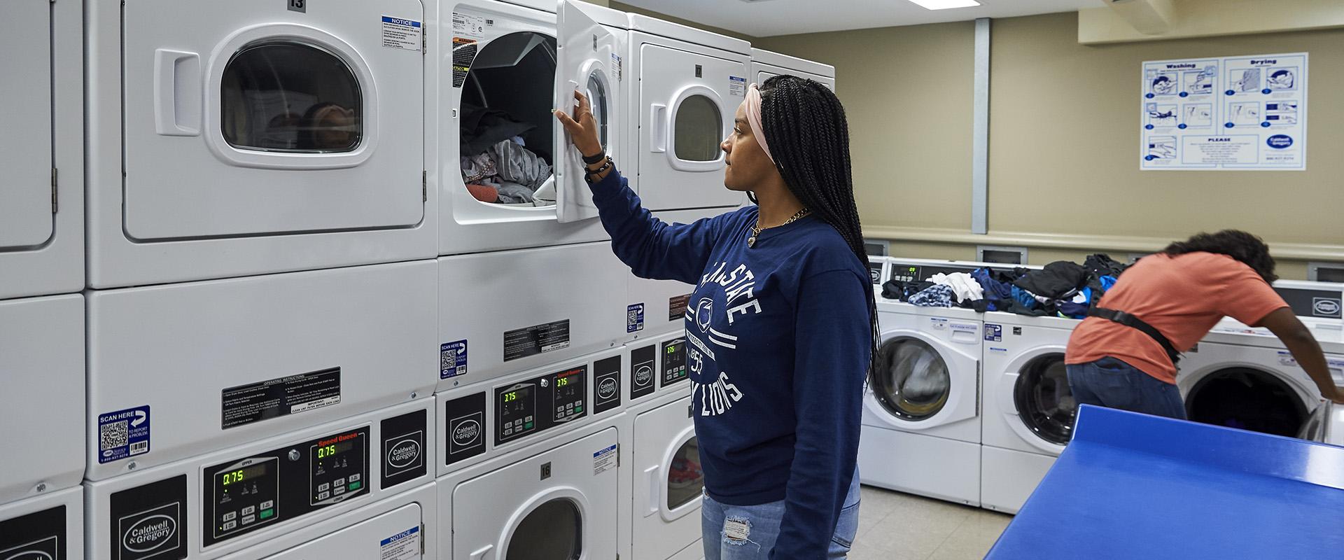 Student checking laundry in Bowman Hall