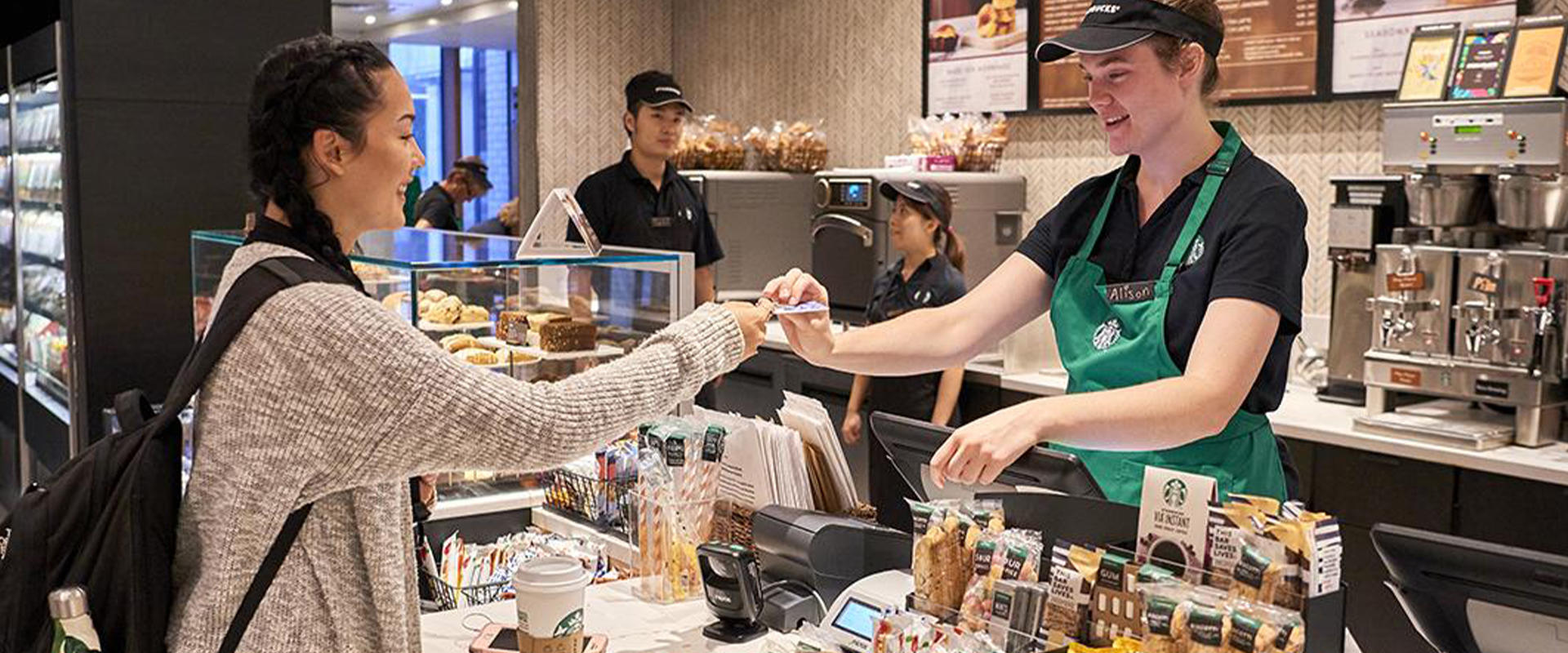 A student "swipes out hunger" at Starbucks witth her meal plan card