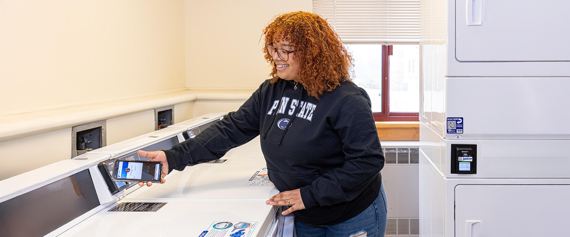 Student uses their mobile phone to pay for laundry services